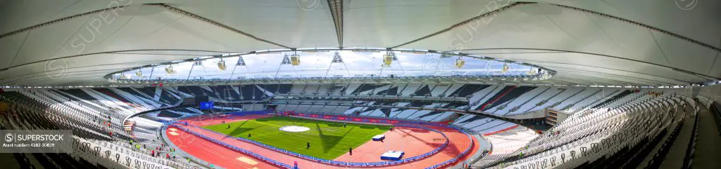 England, London, Stratford . An interior view of the Olympic stadium from the highest seats looking down onto the running track.