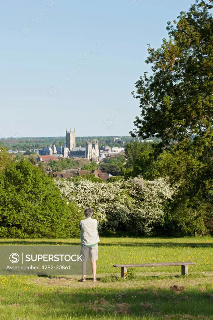 England, Kent, Canterbury. A man admires the view of Canterbury Cathedral.