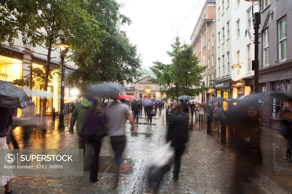 England, London, Covent Garden. A view of people walking in the rain around Covent Garden.