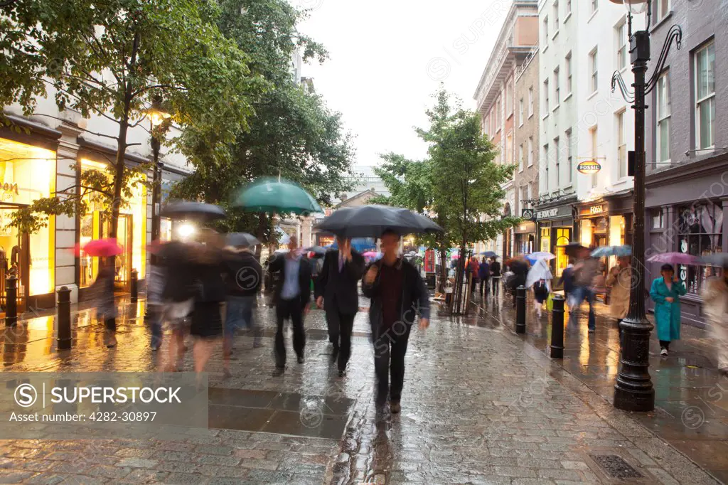 England, London, Covent Garden. A view of people walking in the rain around Covent Garden.