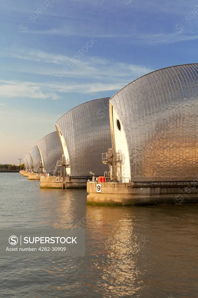 England, London, New Charlton. A view of the Thames Barrier at sunset.