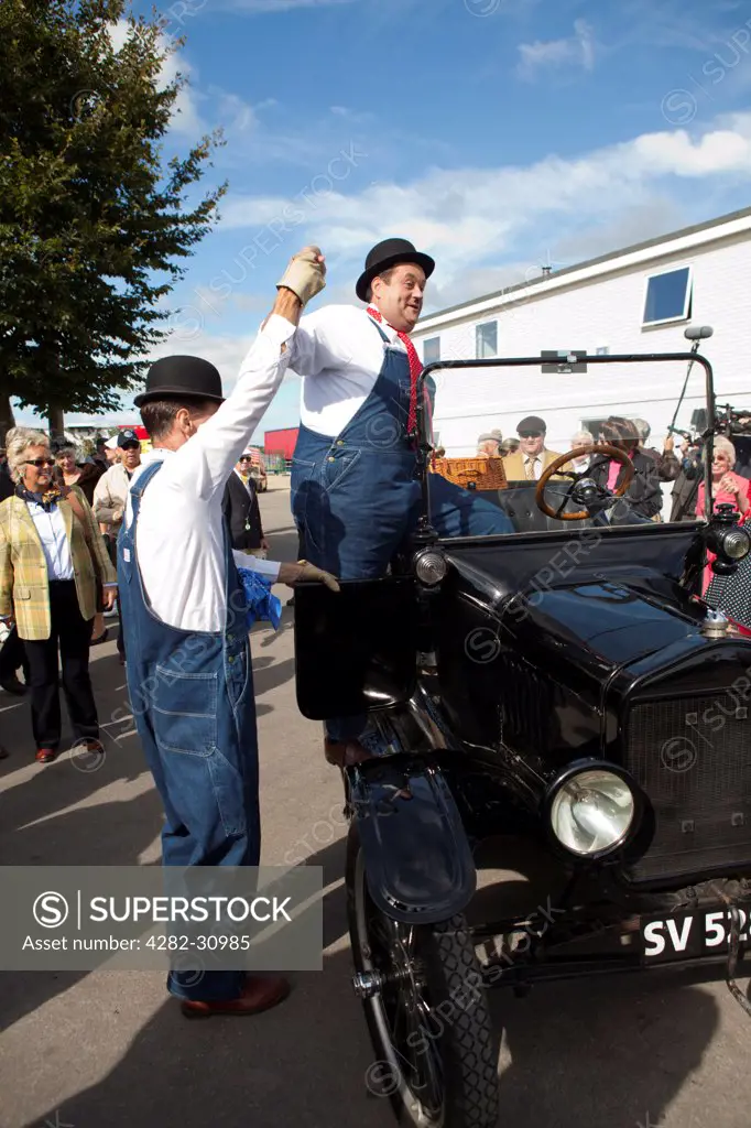 England, West Sussex, Goodwood. Laurel and Hardy lookalikes perform for a crowd at Goodwood revival.