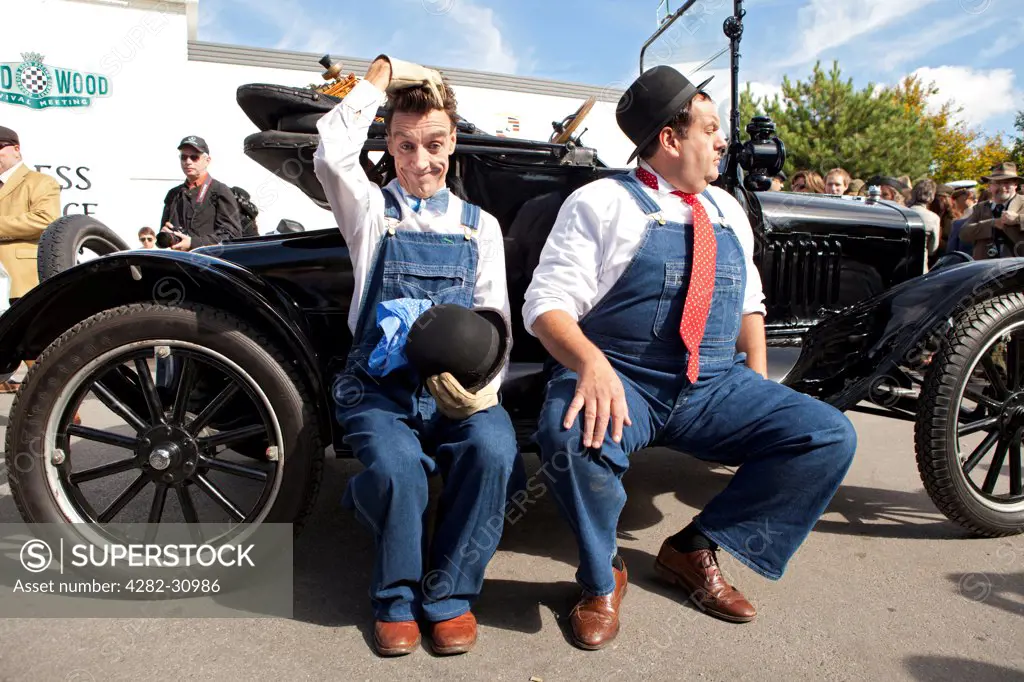 England, West Sussex, Goodwood. Laurel and Hardy lookalikes perform for a crowd at Goodwood revival.