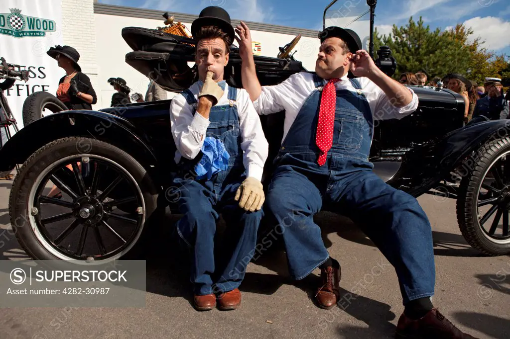 England, West Sussex, Goodwood. Laurel and Hardy lookalikes perform for a crowd at Goodwood revival.