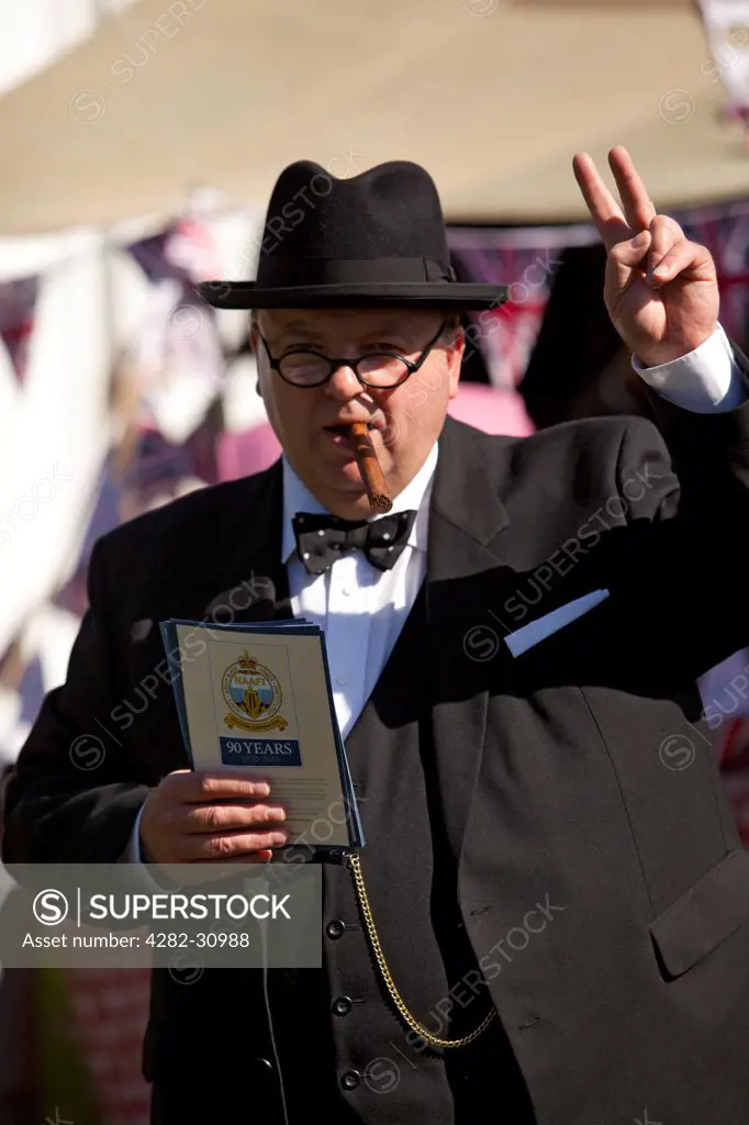 England, West Sussex, Goodwood. A man dressed as Winston Churchill at Goodwood Revival.