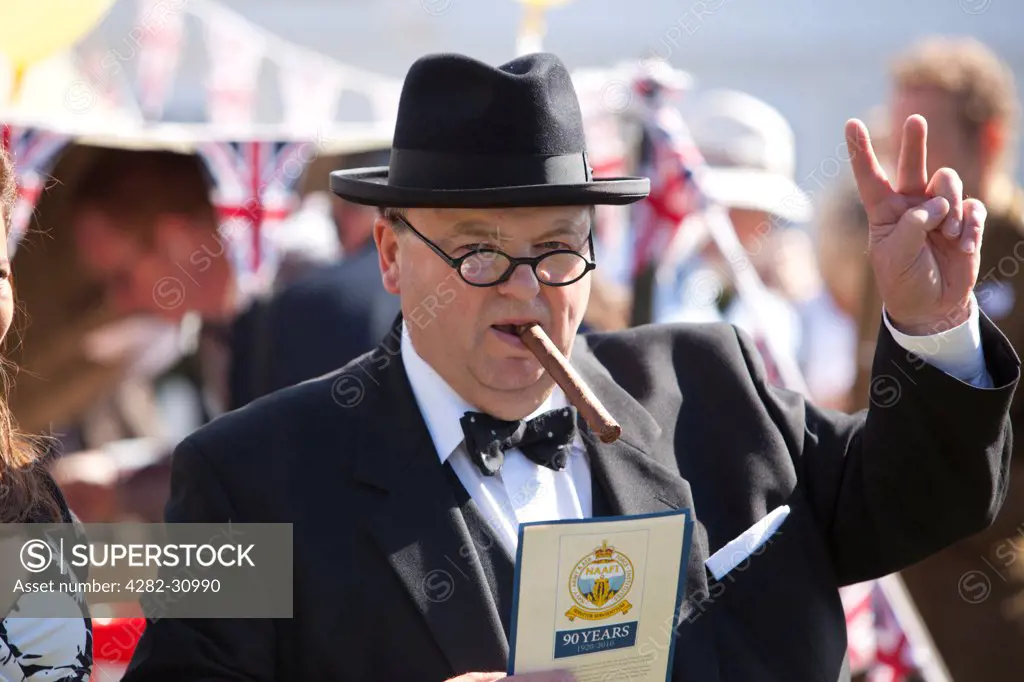England, West Sussex, Goodwood. A man dressed as Winston Churchill at Goodwood Revival.