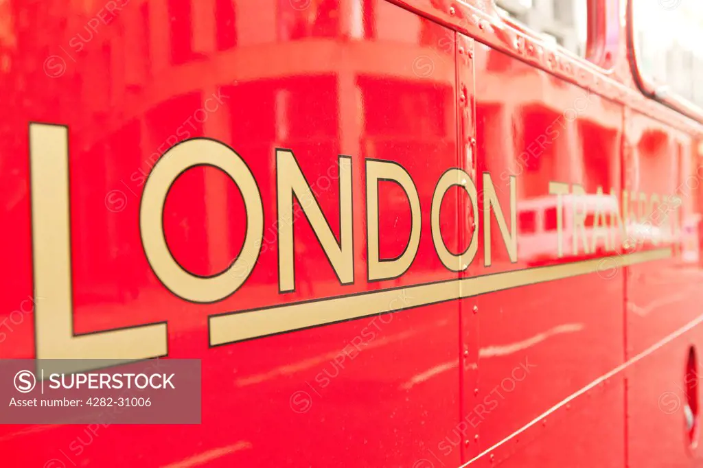 England, London, Bond Street. A sign for London Transport on the side of an old red Routemaster bus.