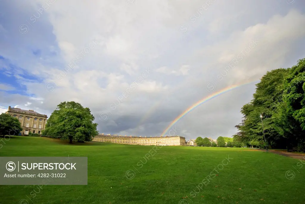 England, Bath and North East Somerset, Bath. A view of the Royal Crescent in Bath with a rainbow overhead.