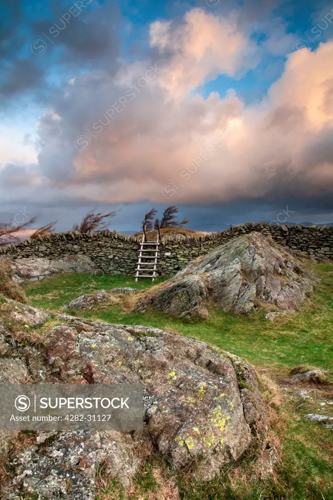 England, Cumbria, Windermere. Stormy skies over Black Crag near Windermere.