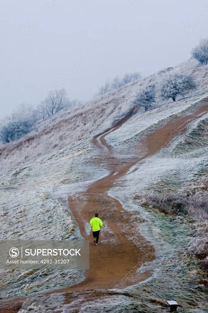 England, Worcestershire, Malvern Hills. A man jogging in the Malvern Hills.