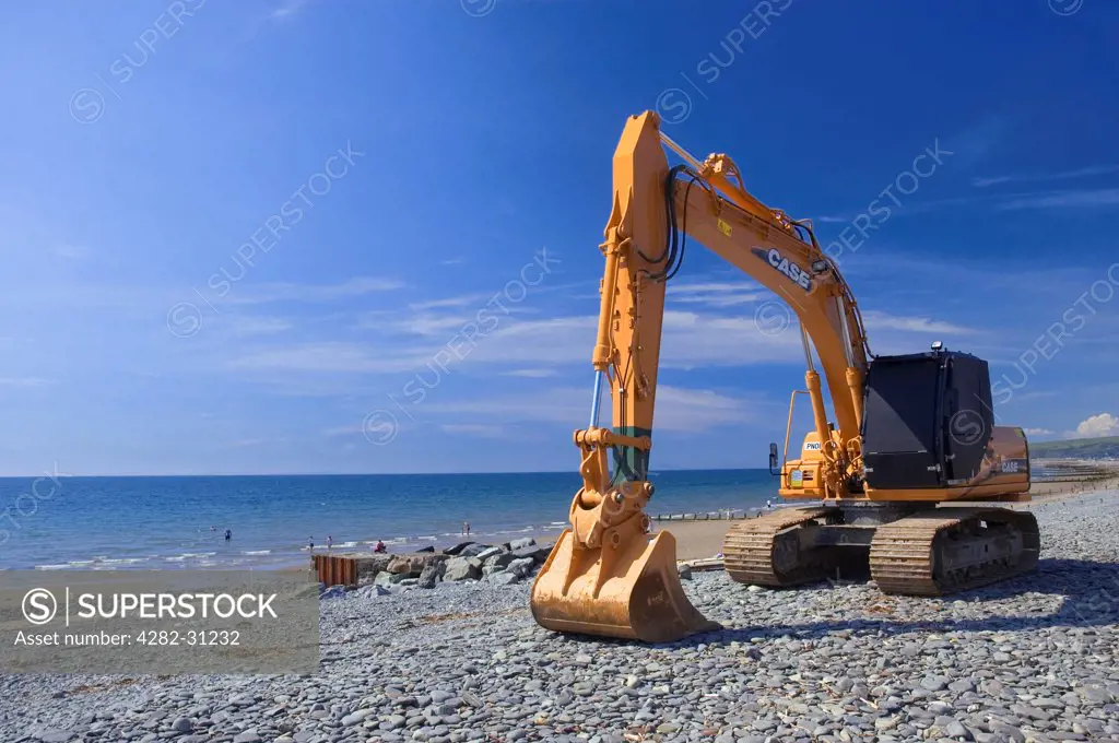 Wales, Ceredigion, Borth. A mechanical digger on the beach at Borth.