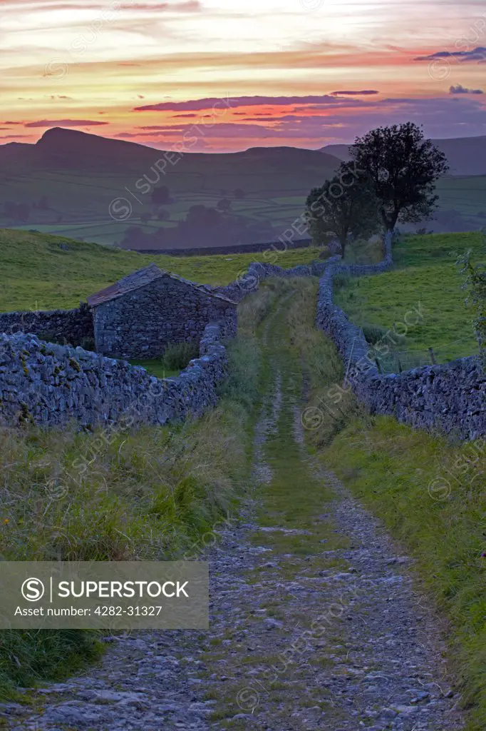 England, North Yorkshire, Stainforth. Sunset over Ribblesdale from Goat Scar lane near Stainforth in the Yorkshire Dales National Park.