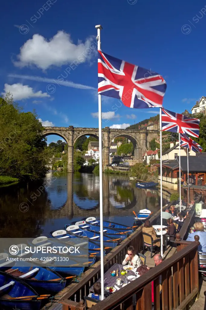 England, North Yorkshire, Knaresborough. A view of the River Nidd from the riverside cafe with the Victorian railway viaduct reflected in the waters below.
