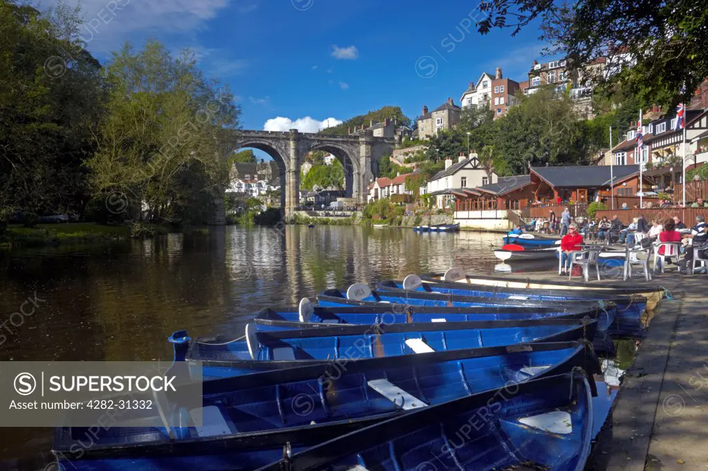 England, North Yorkshire, Knaresborough. Rowing boats on the River Nidd at Knaresborough with the Victorian railway viaduct in the background.