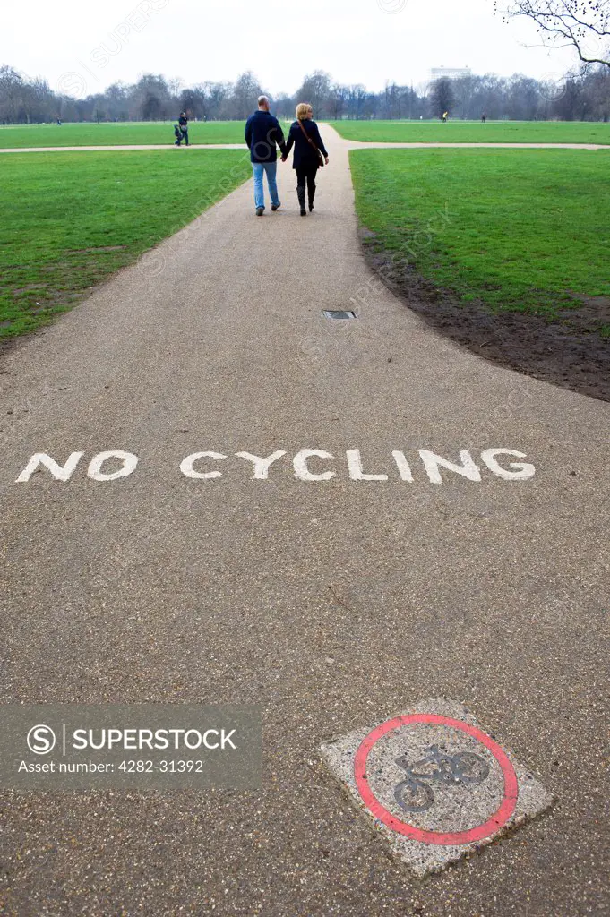 England, London, Hyde Park. A No Cycling sign painted on a path in Hyde Park in London.