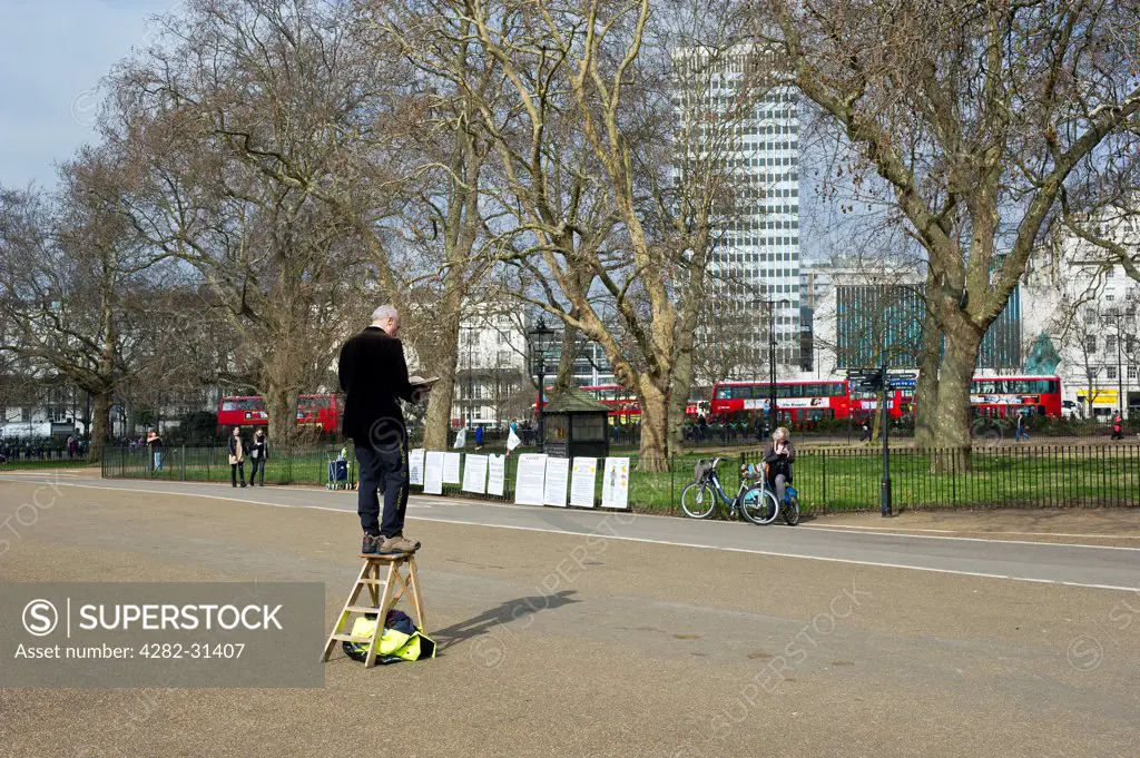 England, London, Hyde Park. A man standing on a wooden stepladder at Speakers Corner in Hyde Park in London.