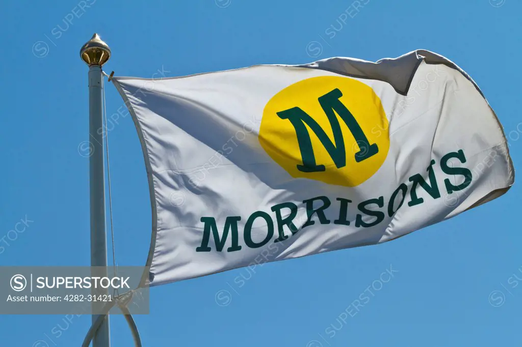 England, Hertfordshire, Borehamwood. A Morrisons retailer flag fluttering outside a store in Hertfordshire.
