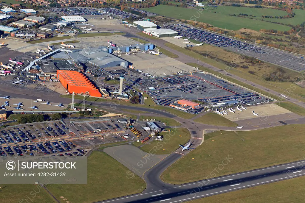England, Bedfordshire, Luton. Aerial view of the main terminal with control tower and apron at London Luton Airport.