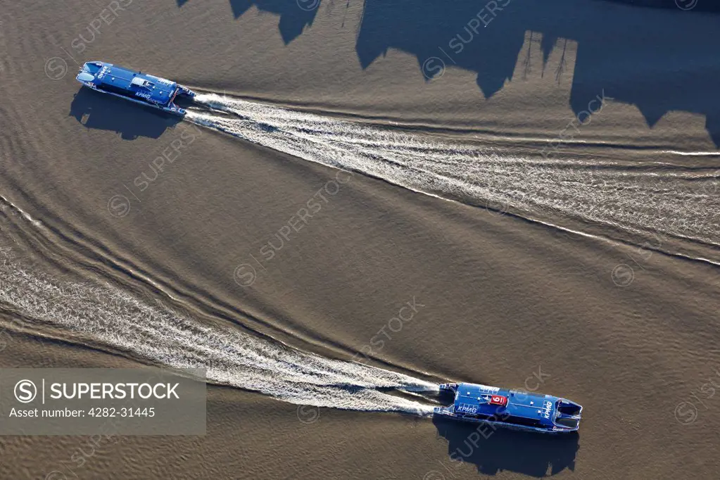 England, London, Westminster. Aerial view of two of the Thames Clipper fleet of catamarans plying their trade on the Thames.