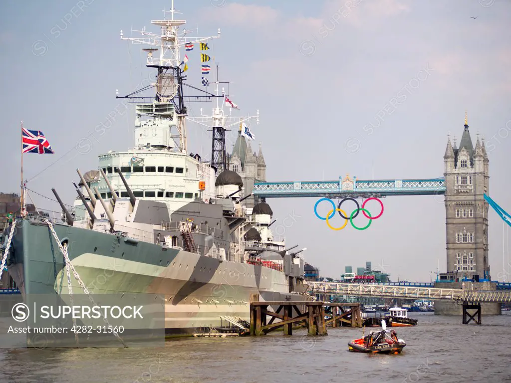 England, London, HMS Belfast. HMS Belfast and Tower Bridge with the Olympic rings.