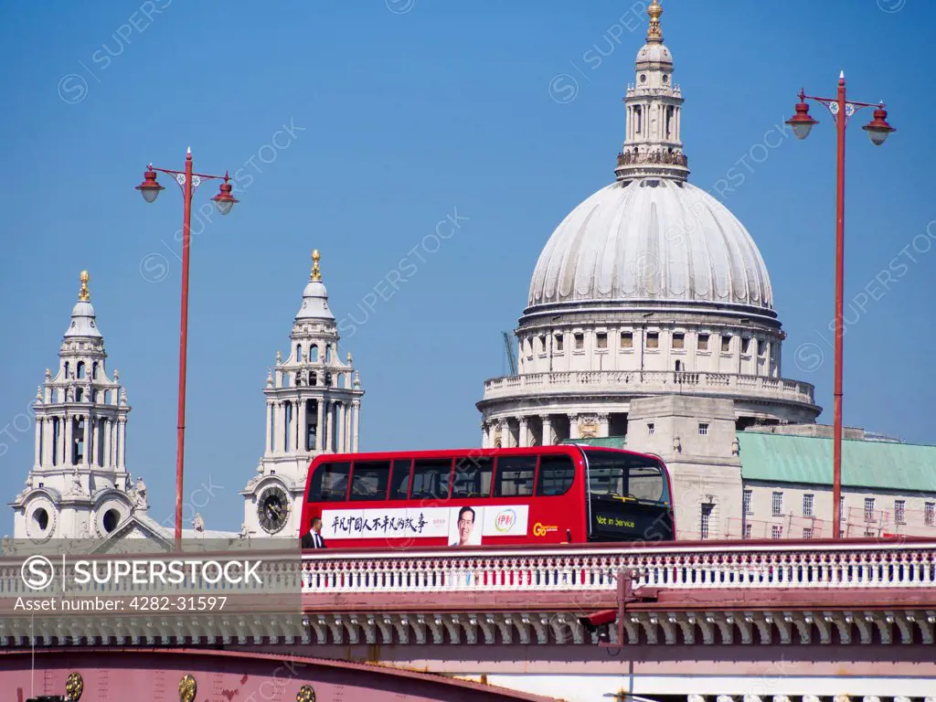 England, London, Blackfriars Bridge. St PaulÛªs Cathedral and Blackfriars Bridge with a traditional red bus crossing.