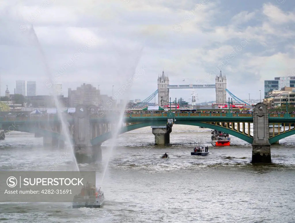 England, London, Southwark Bridge. A fireboat passes under Southwark Bridge during the Thames Festival.