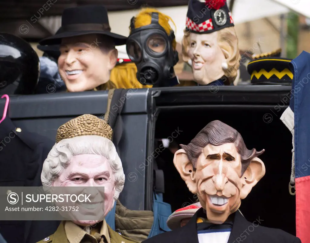 England, London, Portobello Road. Famous faces at a stall selling masks and hats at Portobello Road market.