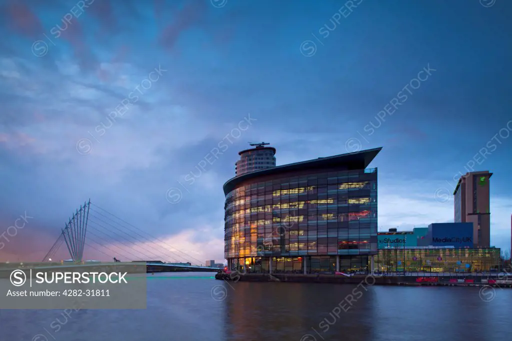 England, Greater Manchester, Salford Quays. Swing bridge and Media City UK buildings located on the Salford Quays in the city of Salford near Manchester Old Trafford.