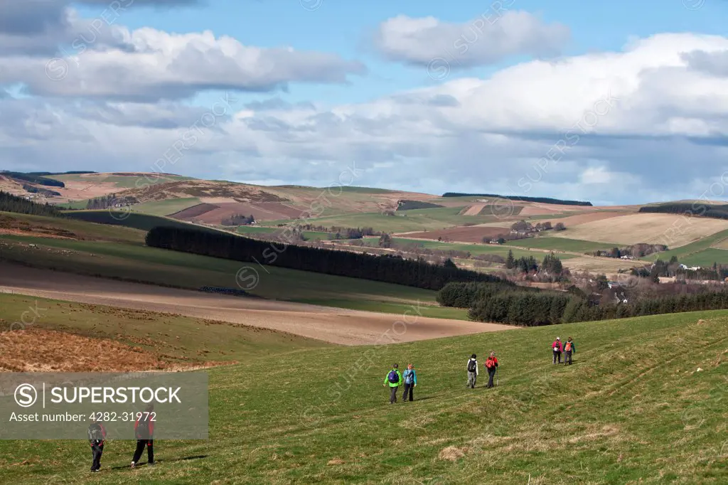 Scotland, Aberdeenshire, Huntly. Hillwalkers on the Clashmach Track in Scotland.