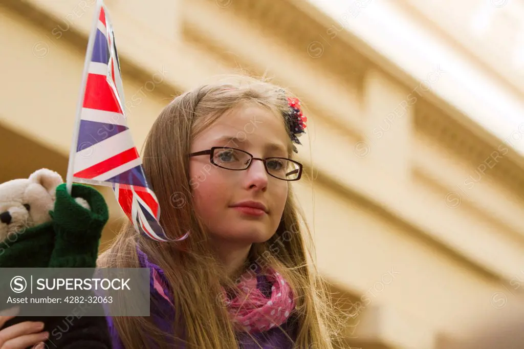 England, London, The Mall. A young spectator on the Mall awaits to see the Trooping of the Colour.