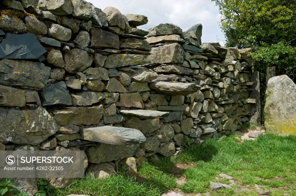 England, Cumbria, Grasmere. Stile set in a dry stone wall.