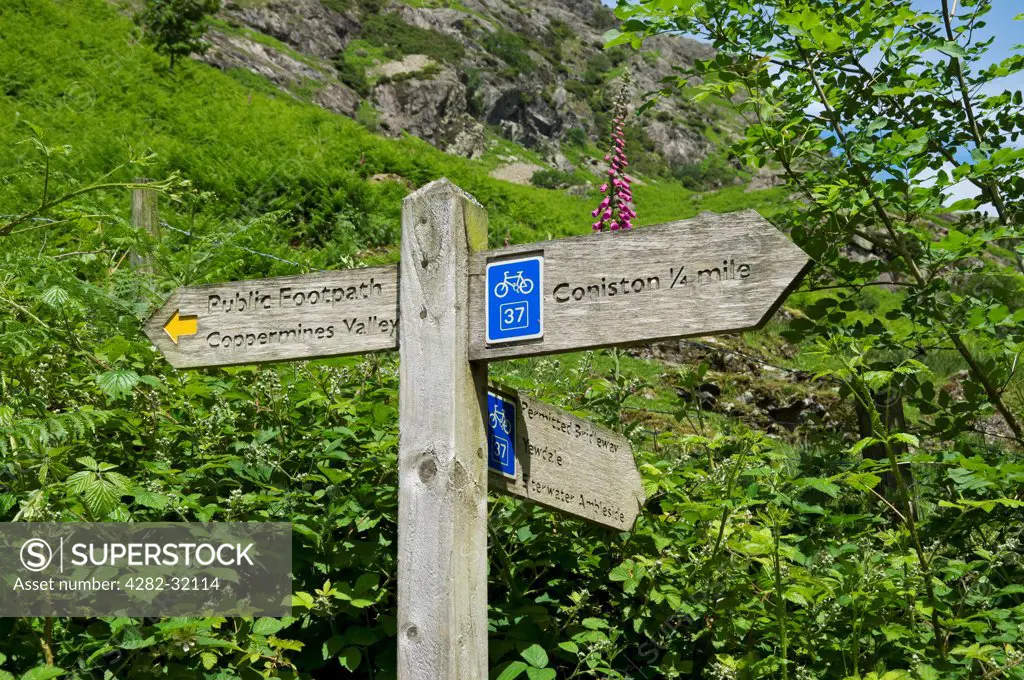 England, Cumbria, Coniston. Public footpath and cycle route signpost.