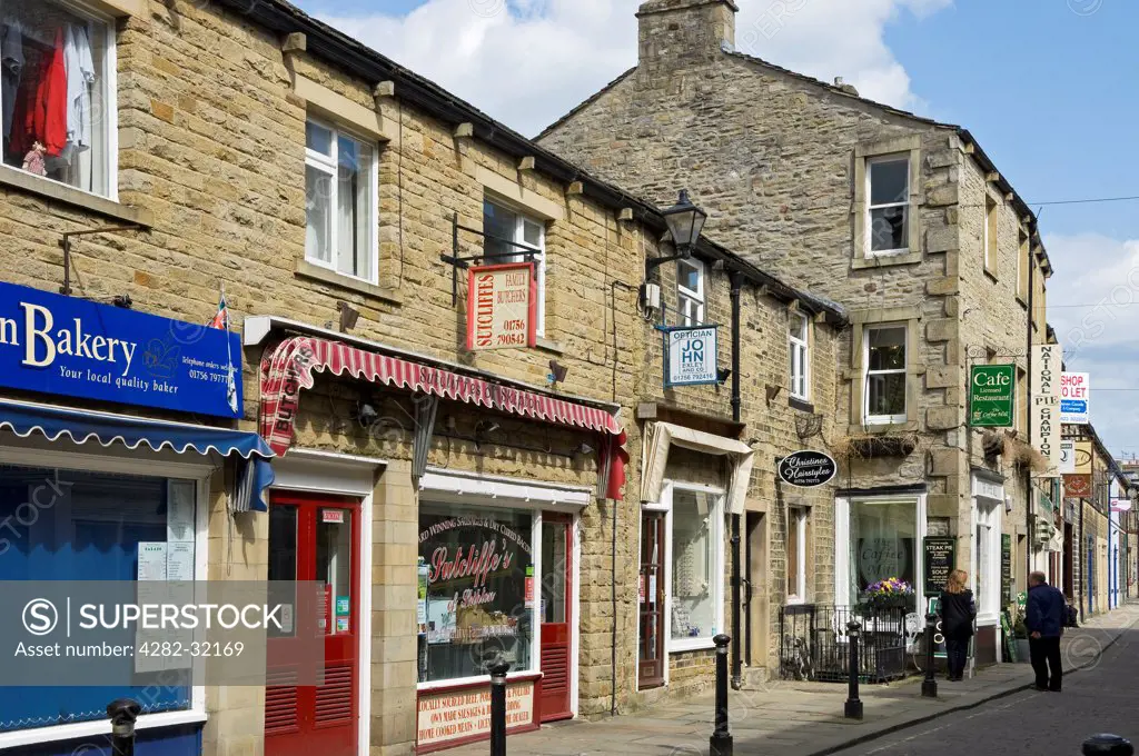 England, North Yorkshire, Skipton. A row of shops in Skipton town centre.