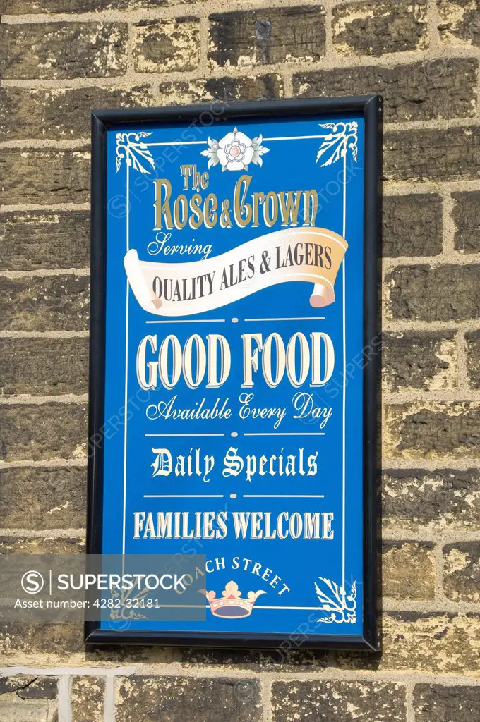 England, North Yorkshire, Skipton. Rose and Crown pub sign on wall.