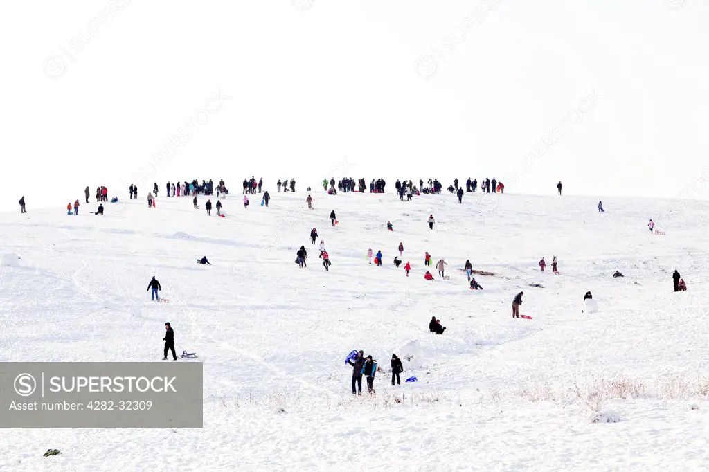 England, London, Hampstead Heath. People sledging on Hampstead Heath in winter.