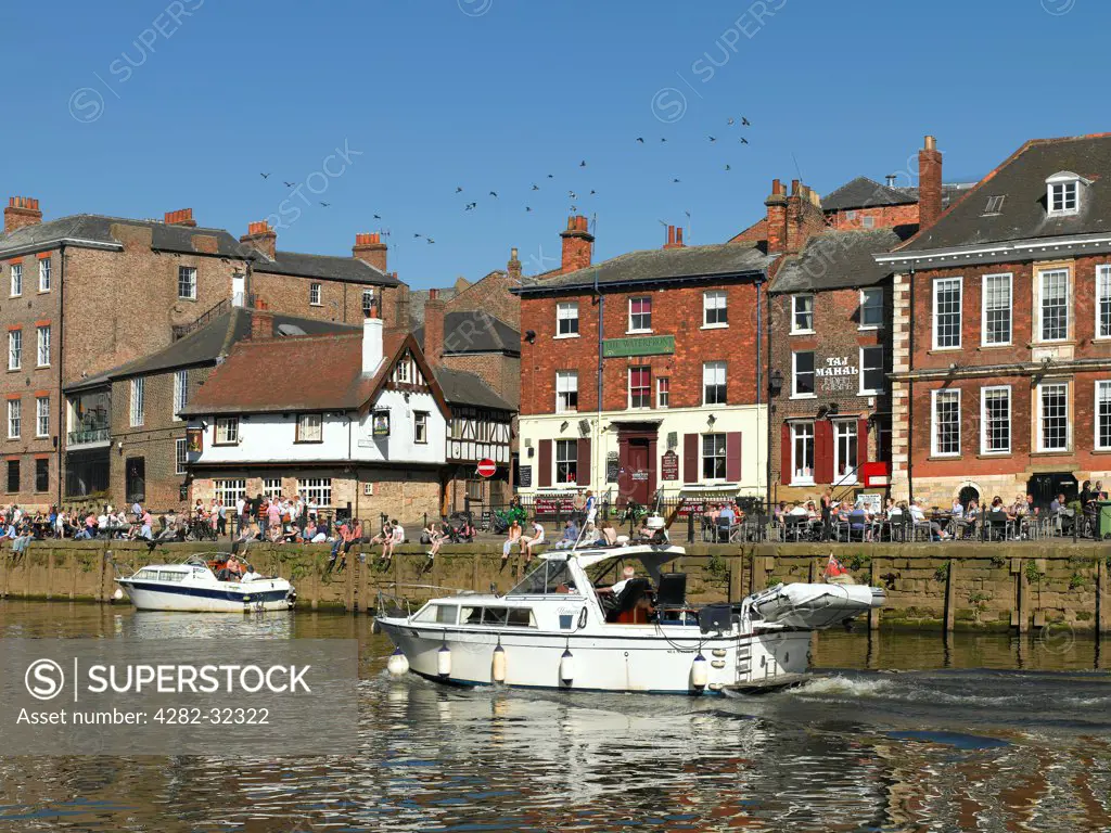 England, North Yorkshire, York. People relaxing along Kings Staith in spring.