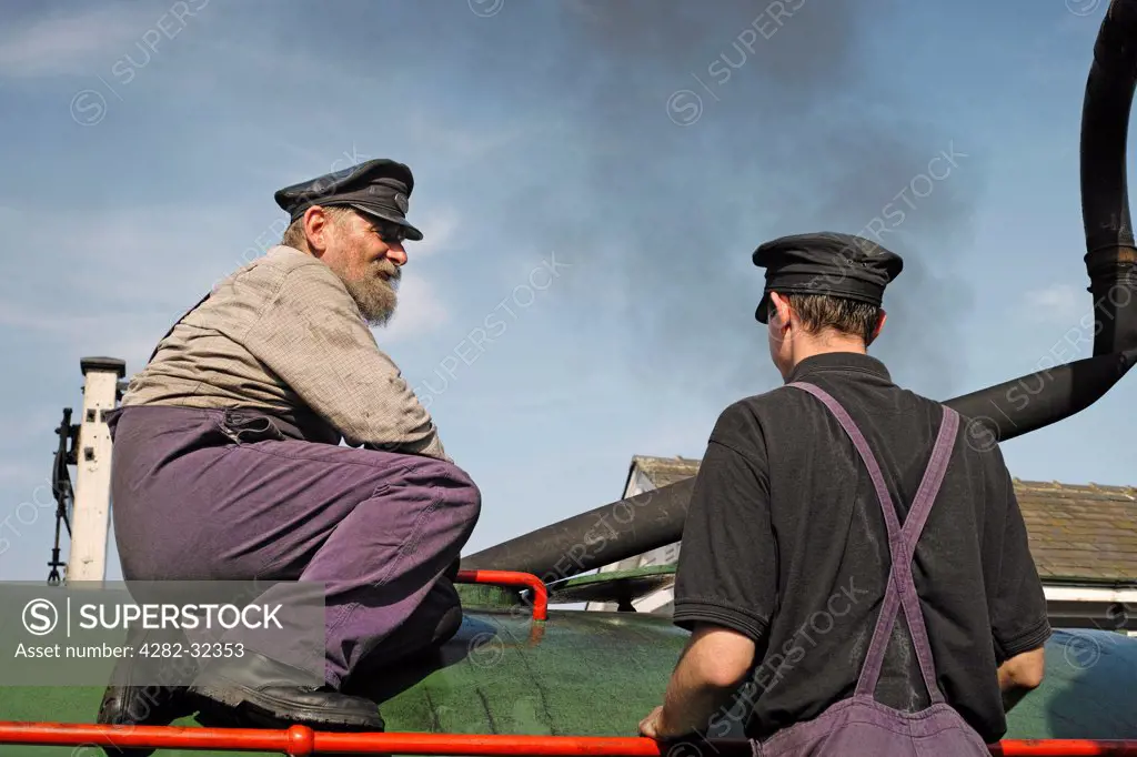 England, Essex, Castle Hedingham. Happy engineer and assistant on a steam train belonging to the Colne Valley Railway.