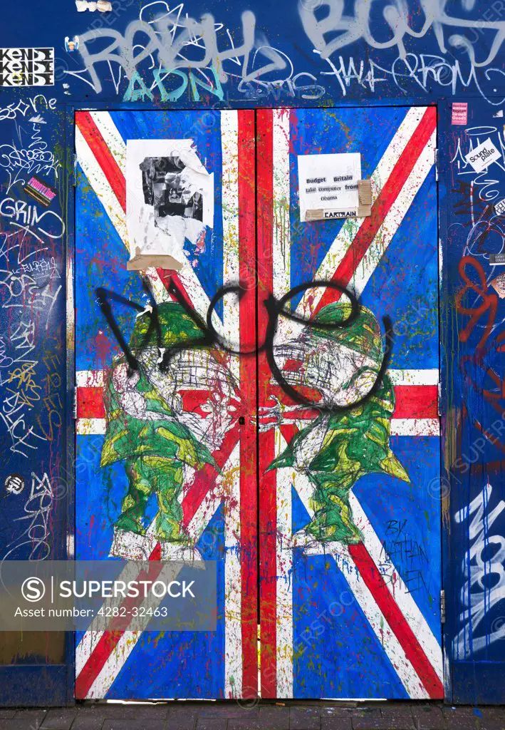 England, London, Shoreditch. Sclater Street art showing a Union Jack door with graffiti.