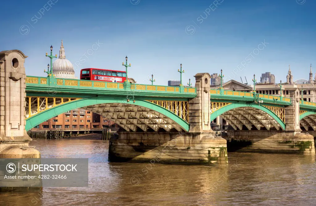 England, London, Southwark Bridge. A bus travels over Southwark Bridge.