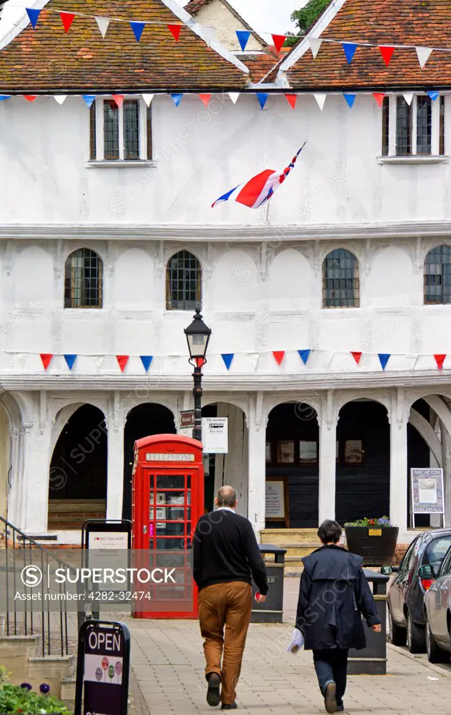 England, Essex, Thaxted. Tourists walk towards the 15th Century Guildhall in Thaxted.