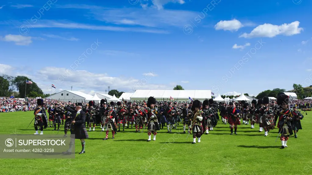 Scotland, City of Edinburgh, Edinburgh. Massed pipes perform in the arena at The Gathering 2009 in Holyrood Park.