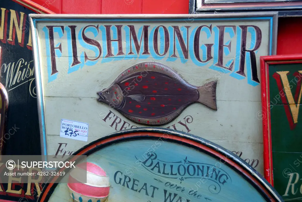 England, London, Portobello Road. Antique fishmonger sign for sale in Portobello market.