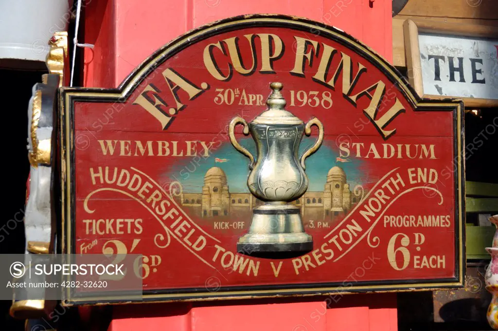 England, London, Portobello Road. Antique FA Cup Final sign for sale in Portobello market.