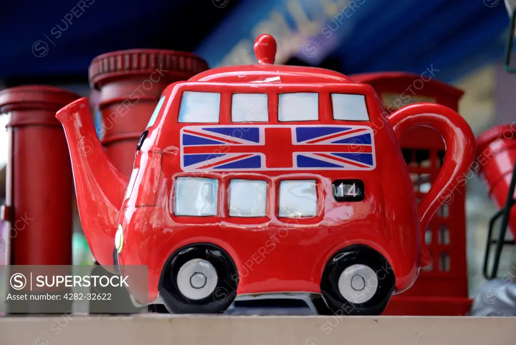 England, London, Portobello Road. A red double decker bus souvenir teapot for sale in Portobello market.
