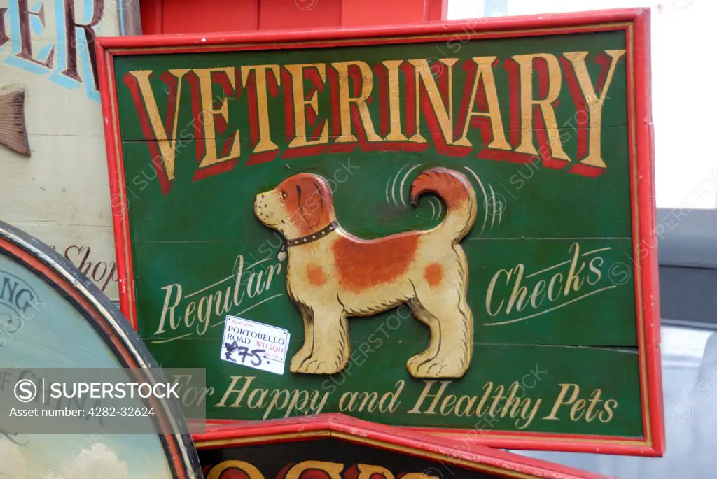 England, London, Portobello Road. An antique veterinary sign for sale in Portobello market.