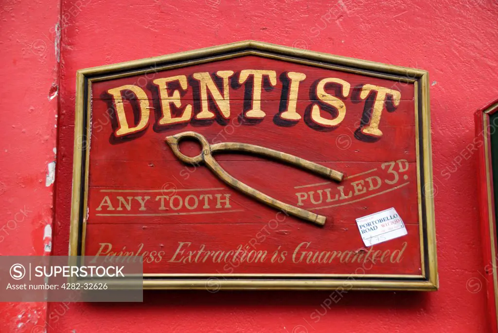 England, London, Portobello Road. An antique dentist sign for sale in Portobello market.