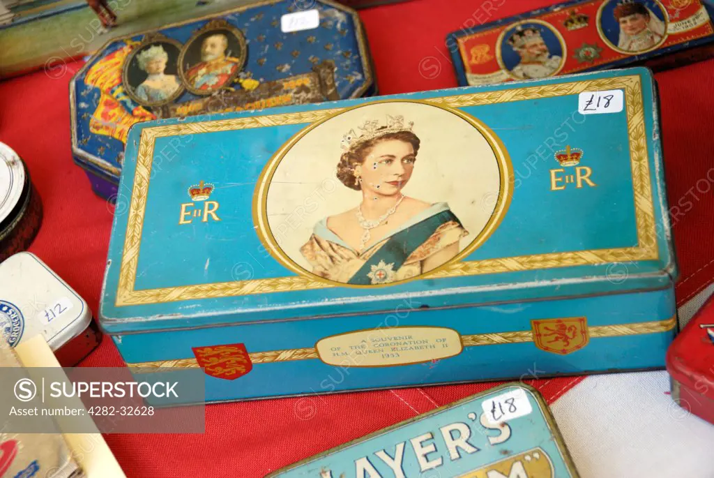 England, London, Portobello Road. Tin boxes bearing images of British monarchs for sale in Portobello market.