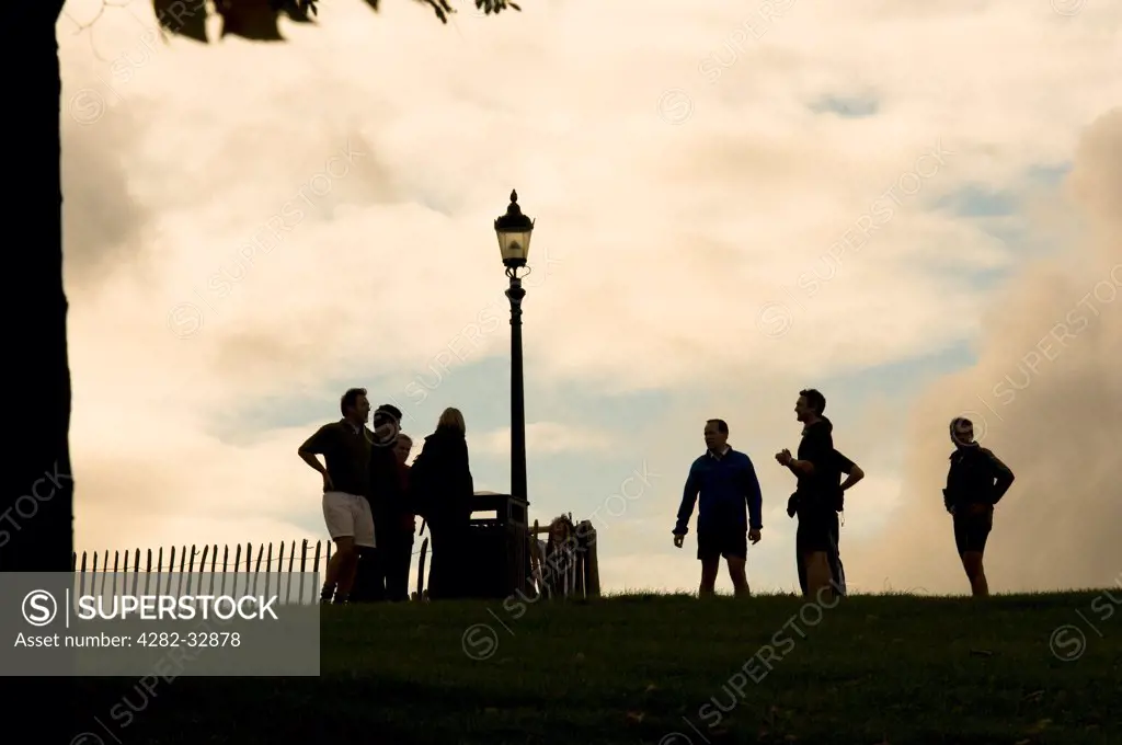England, London, Primrose Hill. Joggers stopping for breath on Primrose Hill.