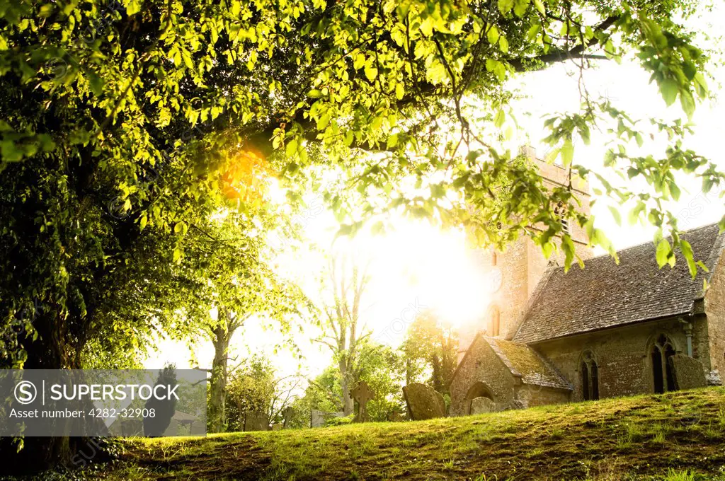 England, Gloucestershire, Broadwell. A Cotswold church in evening sunlight.