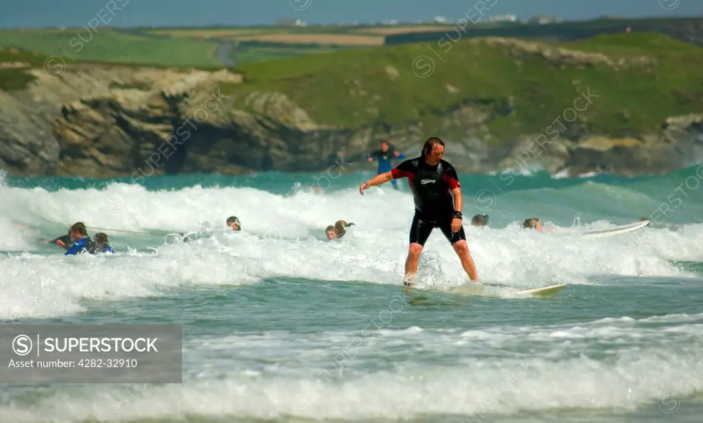 England, Cornwall, Newquay. A surfer in the shallows at Newquay.